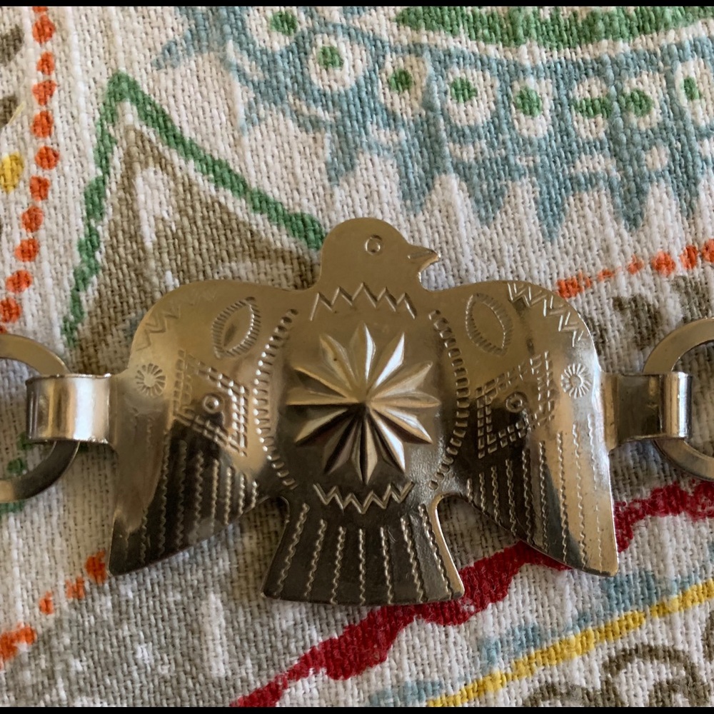 Thunderbird silver tone concho belt.